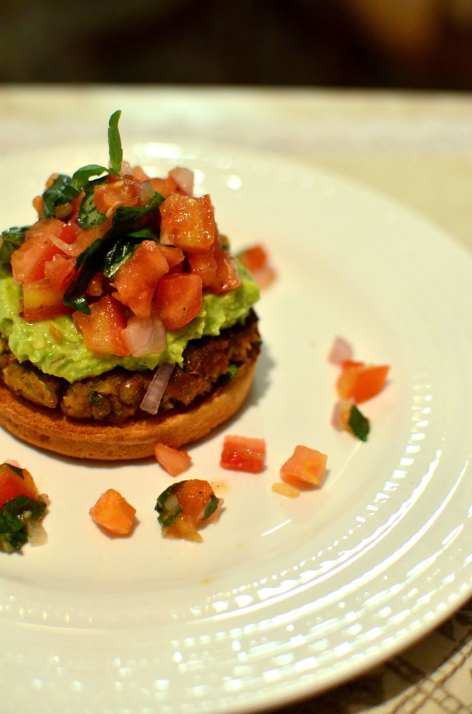 Vegetarian open lentil burger with guacamole and salsa